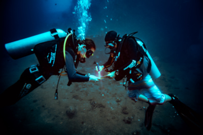 Diver doing PADI Advanced Open water course in Bali- deep dive adventure