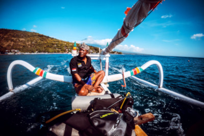 Photo of a traditional jukung boat in Amed with diver and dive gear