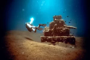 Underwater photography of the pyramid structure with one diver, dive site Pyramids in Amed - Bali